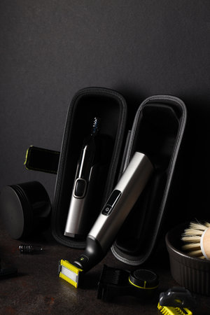 Men's shaving tools in case and cosmetic jar on dark background