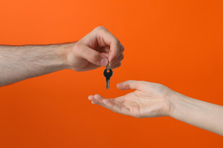 Female and male hand with a keyの写真素材