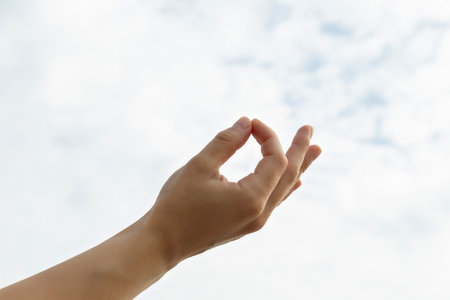 Fingers folded in zen sign on light background, close upの写真素材