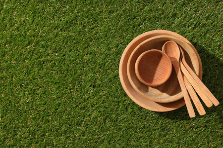 Reusable tableware made of wood on grass.の写真素材