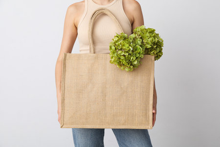 Bag in female hands on a white background