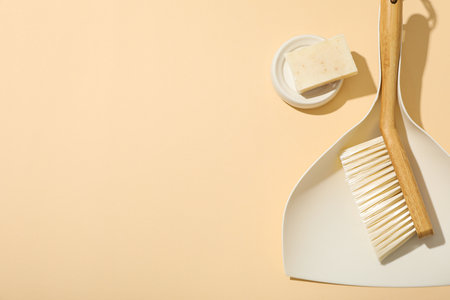 Soap and brush with scoop on beige background, space for textの写真素材
