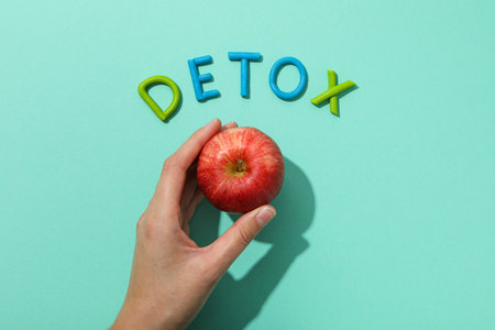The word "detox" is made of colored plasticine on a turquoise background.の写真素材