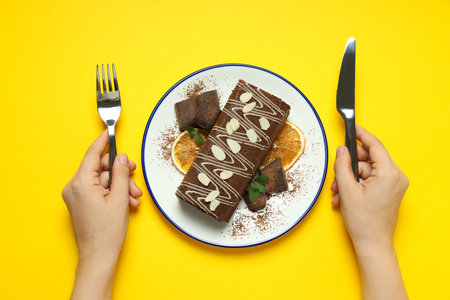 Cake roll in a bowl on a yellow backgroundの写真素材