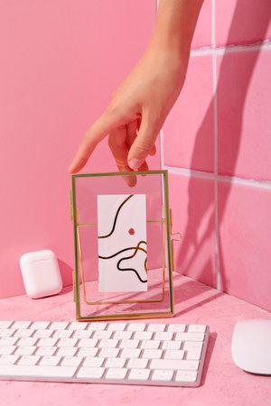 Computer keyboard with mouse and cassette on a pink backgroundの写真素材