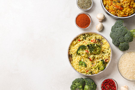 Pilaf in bowls, rice, spice and vegetables on white background, space for textの写真素材