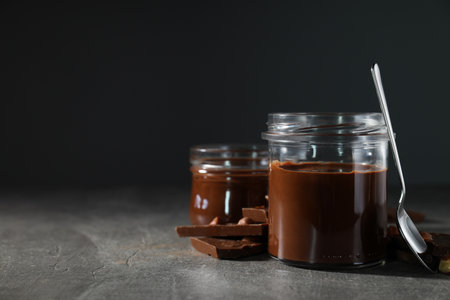 Chocolate paste in a jar on a dark backgroundの写真素材