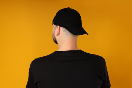 A young guy in a black t-shirt and capの写真素材