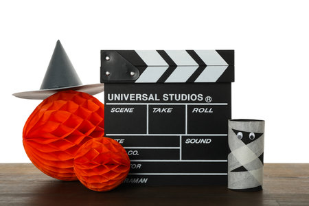 PNG, Clapperboard and Halloween paper decorations on table, isolated on white backgroundの写真素材