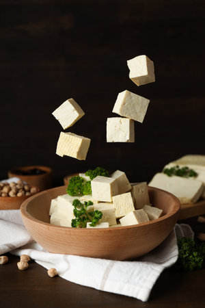 Tofu in a wooden bowl on a dark backgroundの写真素材