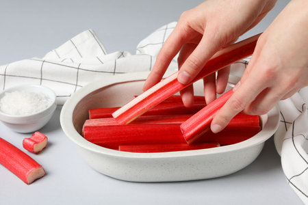 Fresh stalks of rhubarb in white bowlsの写真素材