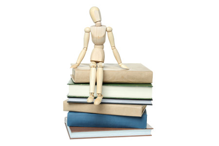 PNG, A stack of books with a wooden man, isolated on white backgroundの写真素材