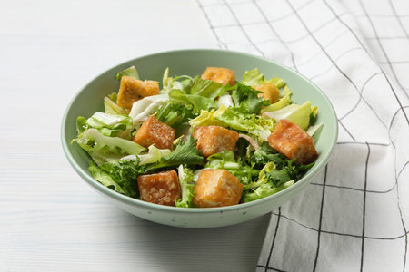 Fried tofu salad in a bowl on a white backgroundの写真素材