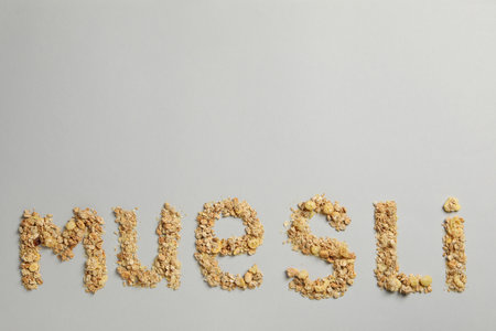 The word muesli from muesli granules on a gray backgroundの写真素材