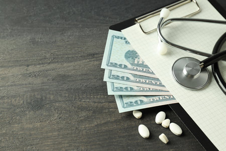 Money with medical equipment, concept of corruption in medicine.