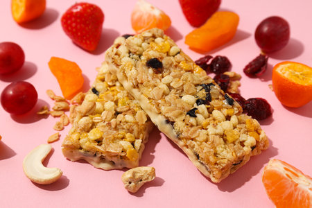 Granola bars with fruit on a pink background
