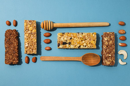 Delicious granola bars with nuts on a blue backgroundの写真素材
