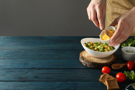 Cheese soup in a bowl with tomatoes on the tableの写真素材