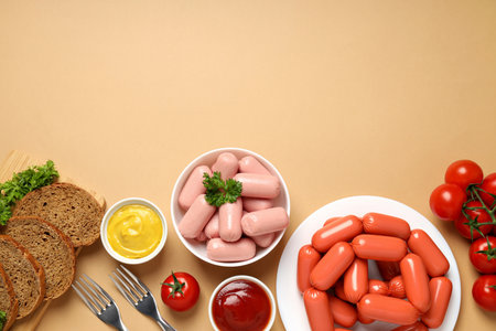 Small sausages in a bowl with fresh tomatoes and breadの写真素材