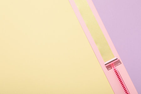Pink razor for shaving on a beautiful backgroundの写真素材