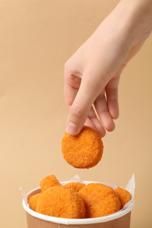 Fried mozzarella in a cardboard box on a beige backgroundの写真素材