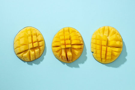 Ripe sliced mango on a blue backgroundの写真素材