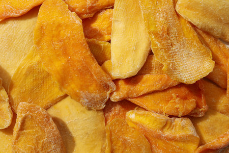 Dried mango chips on a white backgroundの写真素材