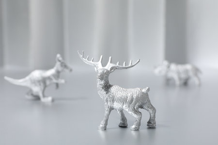Silver animals figurines on gray background, close upの写真素材