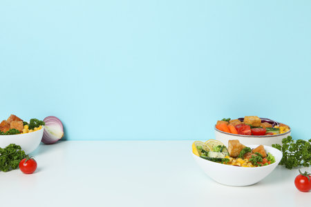 Fried tofu salad with fresh vegetables on a white tableの写真素材