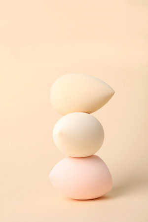 Beige makeup sponges on a beige backgroundの写真素材