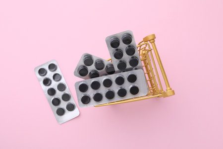 Activated charcoal tablets in a metal basket, top view.の写真素材