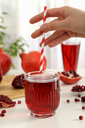 Pomegranate juice with fresh pomegranates on a white backgroundの写真素材