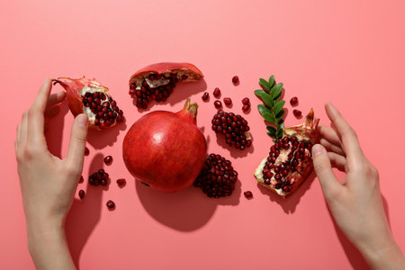 Fresh juicy pomegranate on a pink backgroundの写真素材