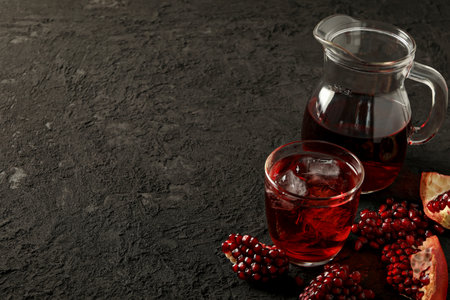 Pomegranate juice with fresh pomegranates on the tableの写真素材
