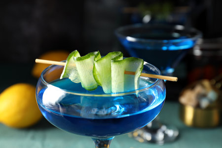Blue cocktail with cucumber slices in glasses on dark background, close upの写真素材