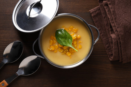 Corn soup in a pot, on a brown background.の写真素材