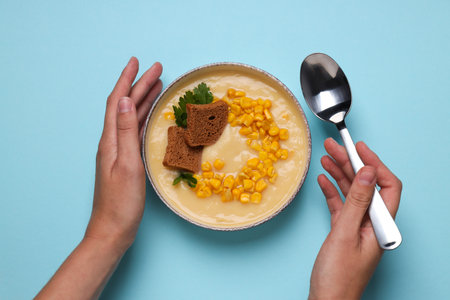 Corn soup in a plate, on a blue background.の写真素材