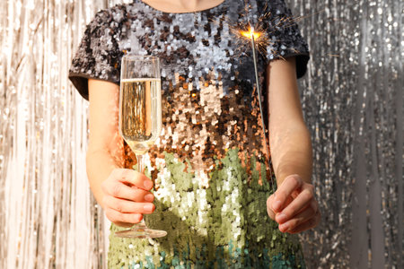 A glass of champagne in the hands of a womanの写真素材