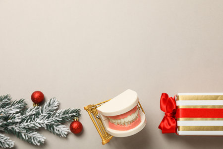 Teeth with Christmas accessories around, flat lay.