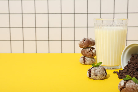 Appetizing Grinkle cookies with milk, on a yellow background.の写真素材