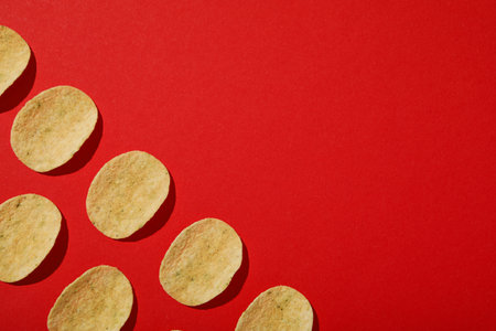 Crispy potato chips on a red backgroundの写真素材
