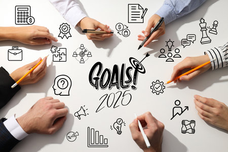Goals 2025, hands of colleagues on a light office table, planning.の写真素材