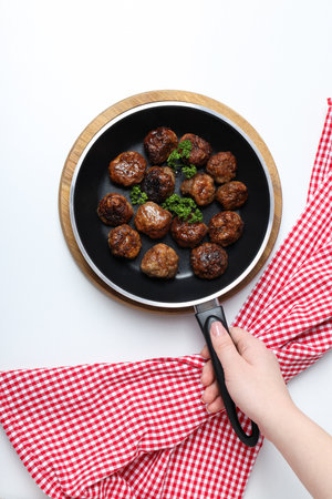 Meatballs in a frying pan on a white backgroundの写真素材