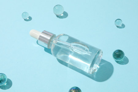 Transparent cosmetic bottles on a blue background