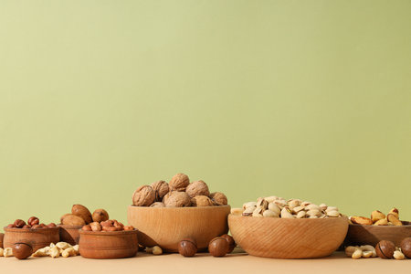 Various nuts in wooden bowls on a light backgroundの写真素材