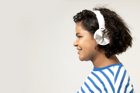 Young African American woman listening to music in headphones