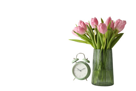 a bouquet of pink tulips in a vase and a green alarm clock, space for text, isolated on white background, PNGの写真素材