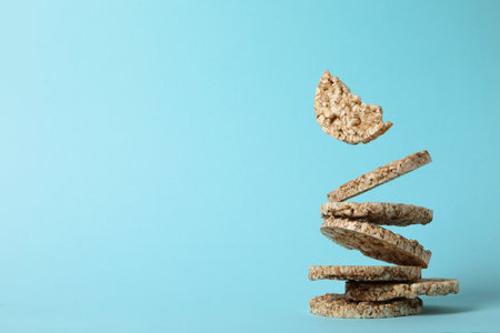 Crisps bread levitated, on a blue background.