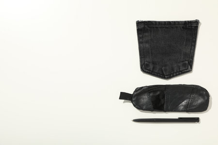 Denim pocket, handmade case and pen on white background, space for textの写真素材
