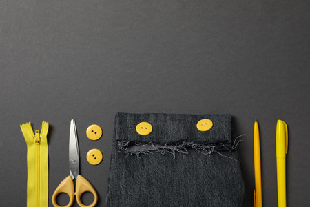 Denim handmade bag, tools and materials on gray background, space for textの写真素材
